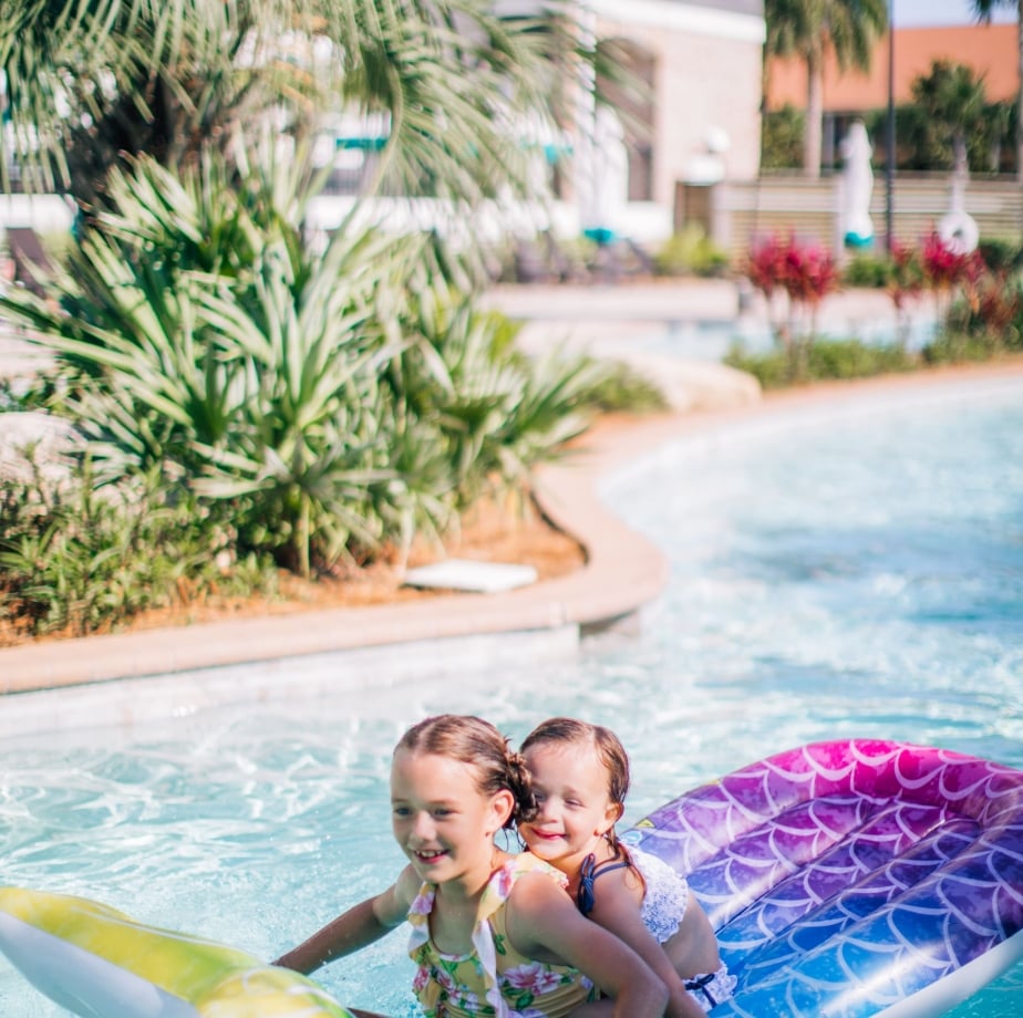kids on pool float in pool