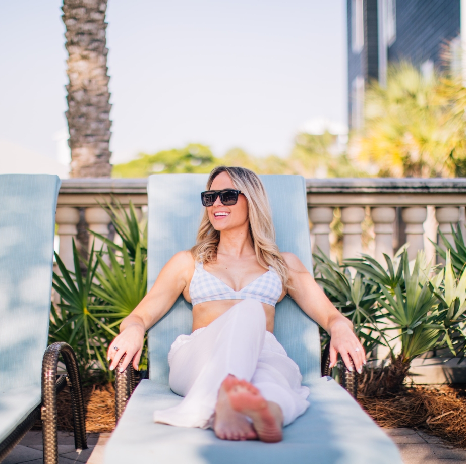 woman lounging on pool chair